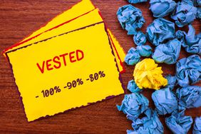 A sticky note that says vested, with percentages