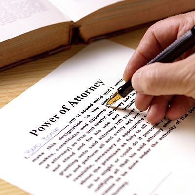 Hand signing a power-of-attorney form