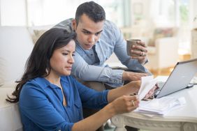 couple filing taxes on the computer