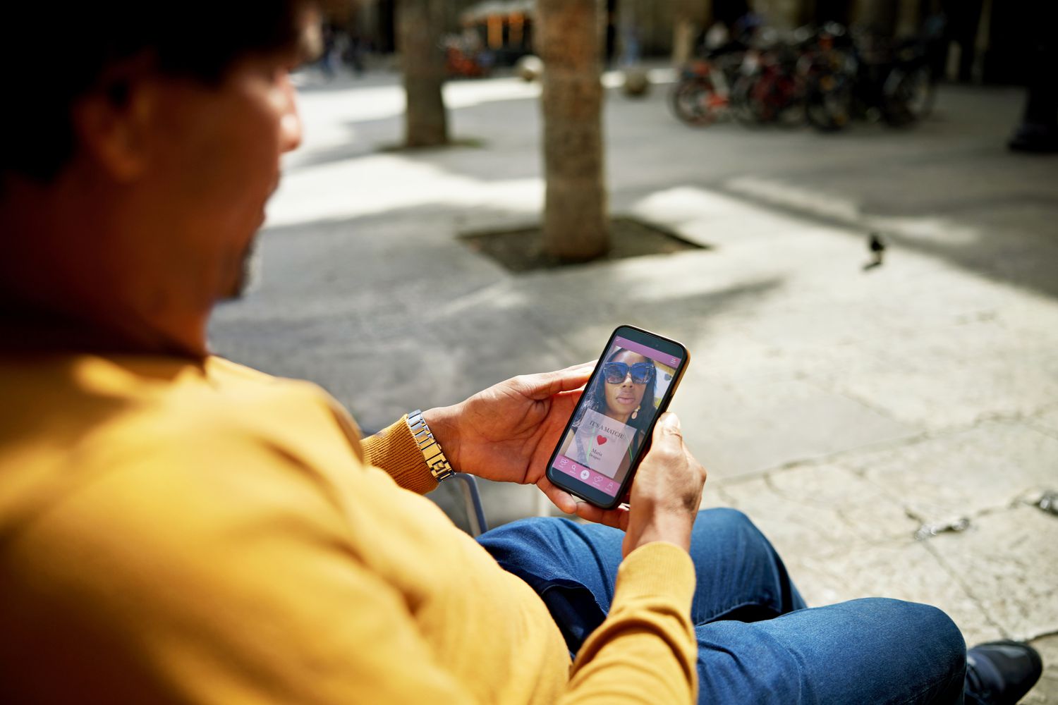A man uses a dating app on his phone. 