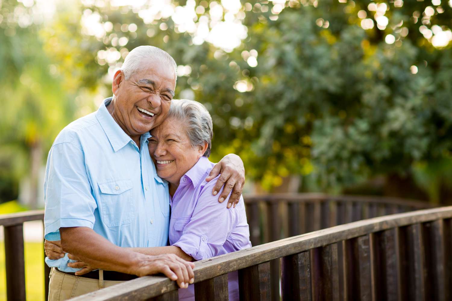 Couple laughing on a bridge