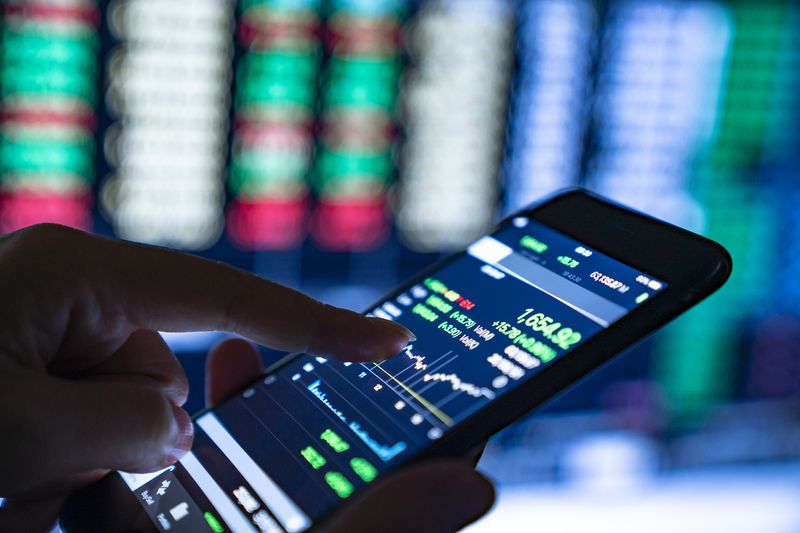 Close-Up of Hands of Businesswoman Analyzing Stock Market Charts and Key Performance Indicators