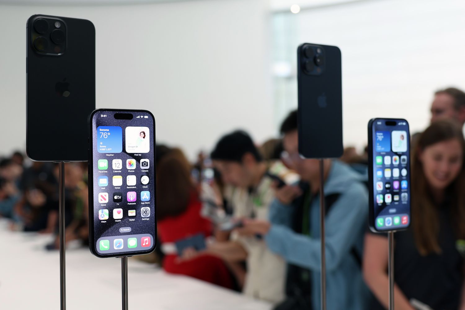 Attendees look at new Apple products during an Apple event on Sept. 12, 2023, in Cupertino, California.