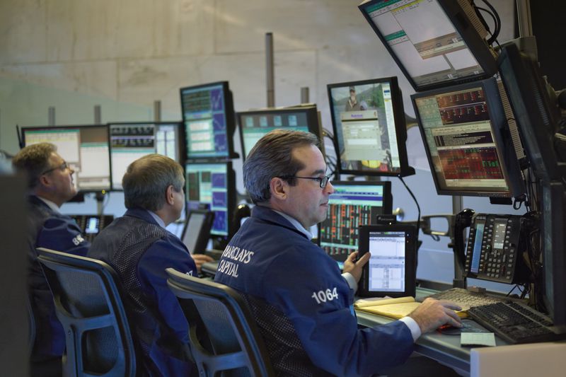Traders working in front of banks of computers