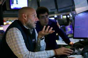 Traders work on the floor of the New York Stock Exchange.