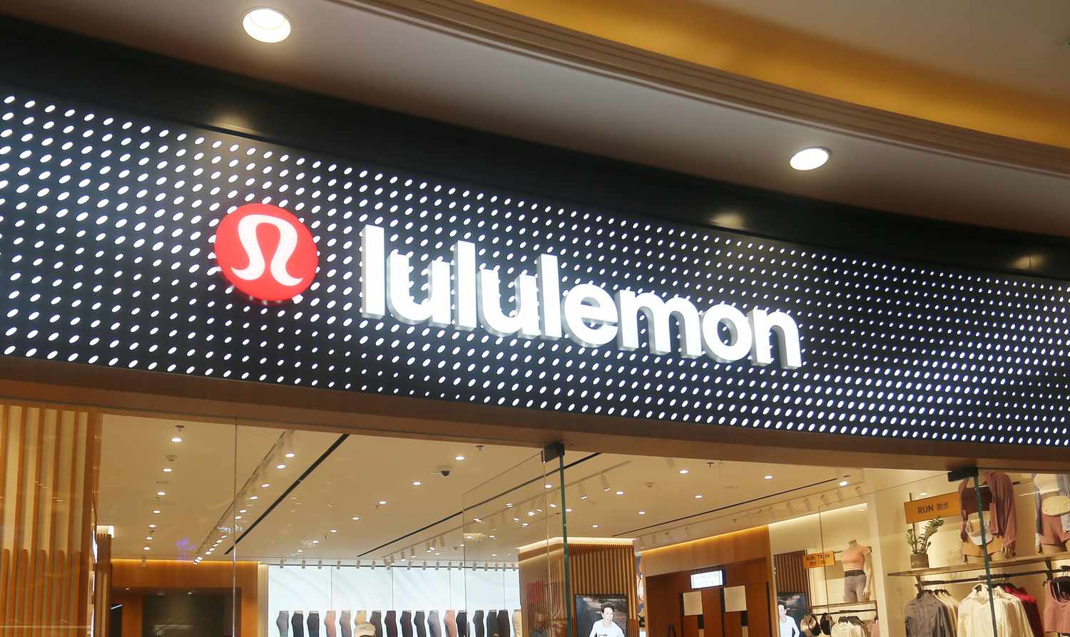 The Lululemon logo is seen above the entrance to a store.