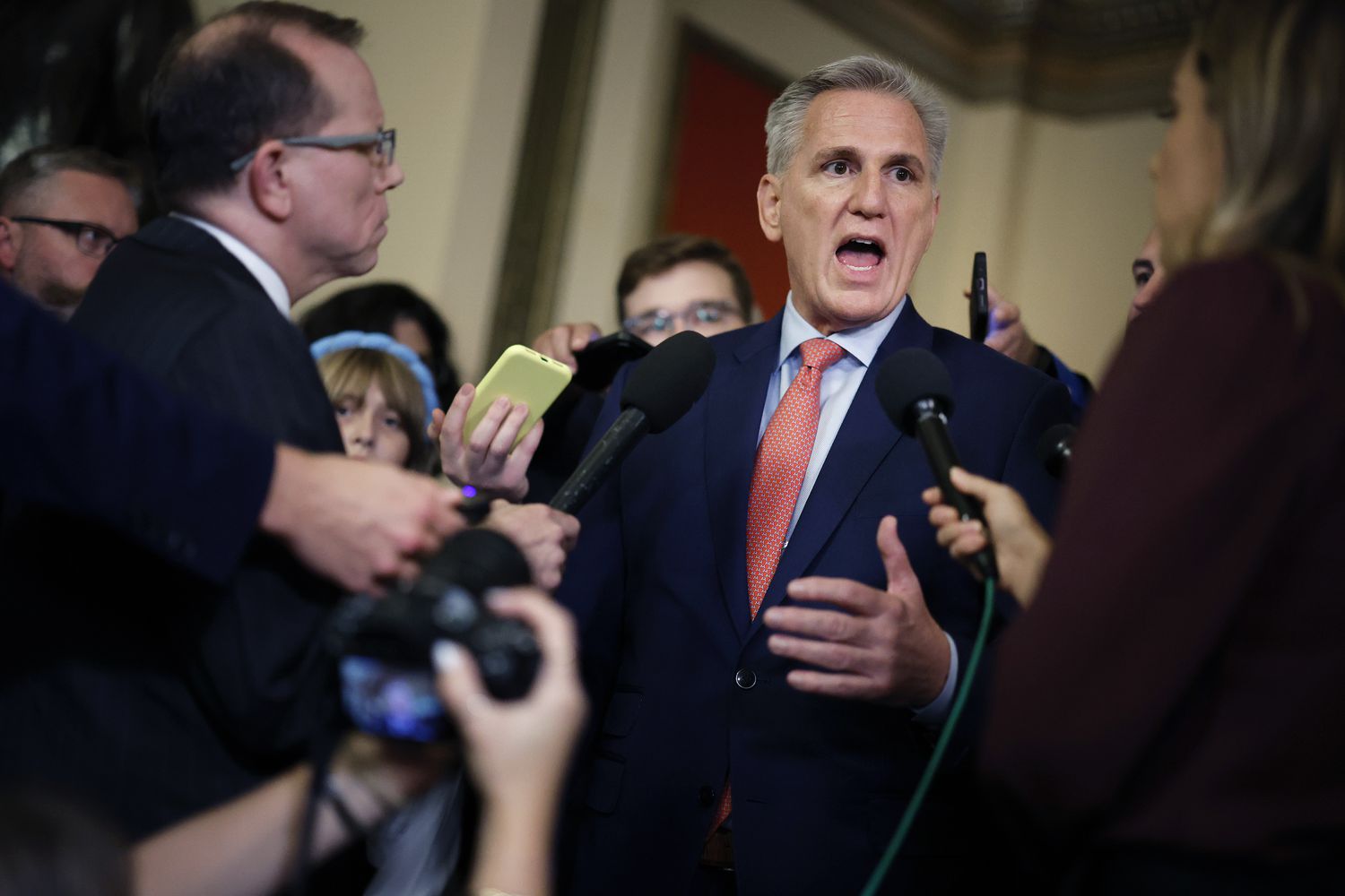Speaker of the House Kevin McCarthy (R-CA) pauses to talk to reporters as he heads to the House Chamber for a vote at the U.S. Capitol on September 27, 2023 in Washington, DC. McCarthy continues to look for a legislative path that would prevent the federal government from partially shutting down at midnight on September 30 while also preserving his speakership.