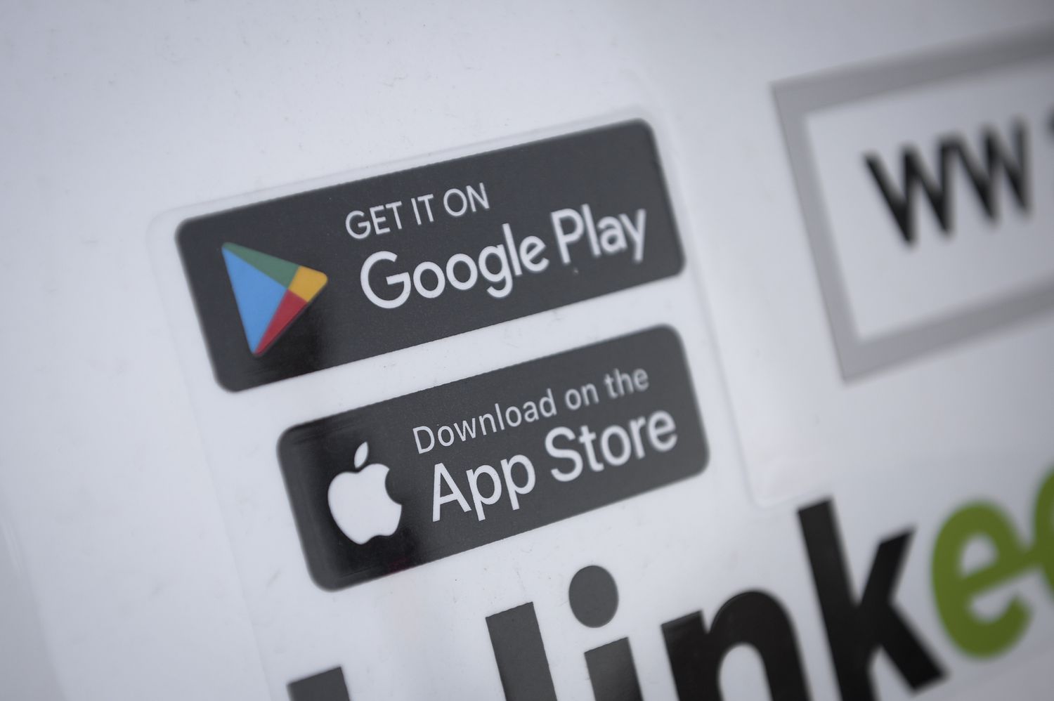 The Google Play and Apple App Store logos on display in promotional material for users to download an app.