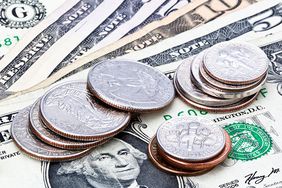 Close-up of U.S. dollar banknotes and stacks of coins