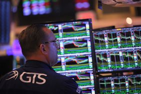 Traders work on the floor of the NYSE