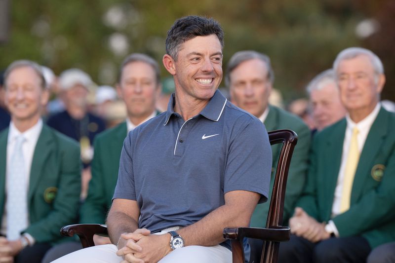 Golf: The Masters: Rory McIlroy victorious during green jacket ceremony after winning sudden death playoff round to win the tournament on Sunday at Augusta National. 