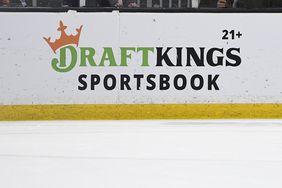 The DraftKings Sportsbook logo is seen on the boards around the edge of an ice hockey rink.