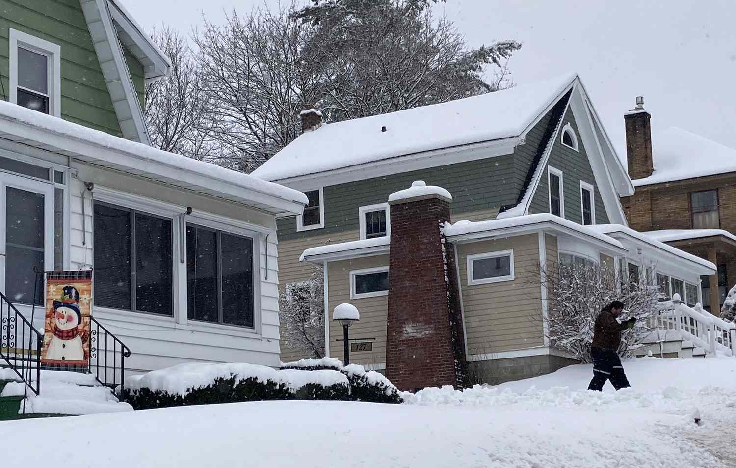 A snowman flag is seen on the front of a house during a powerful winter storm which brought as much as 14 inches of snow to the Northeast, on January 7, 2024 in the village of Canajoharie, N.Y.