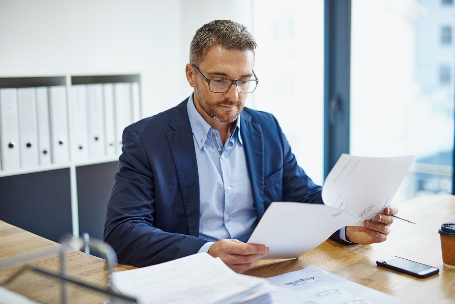 A Securities and Exchange Commission regulator reviews forms received from an investment firm associated with American Depositary Receipts they offer.