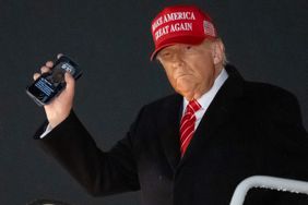 US President Donald Trump disembarks from Air Force One while holding his cellphone with a text message from Roger Stone upon arrival at Joint Base Andrews in Maryland, May 30, 2025, after traveling to Pennsylvania to visit a US Steel plant.