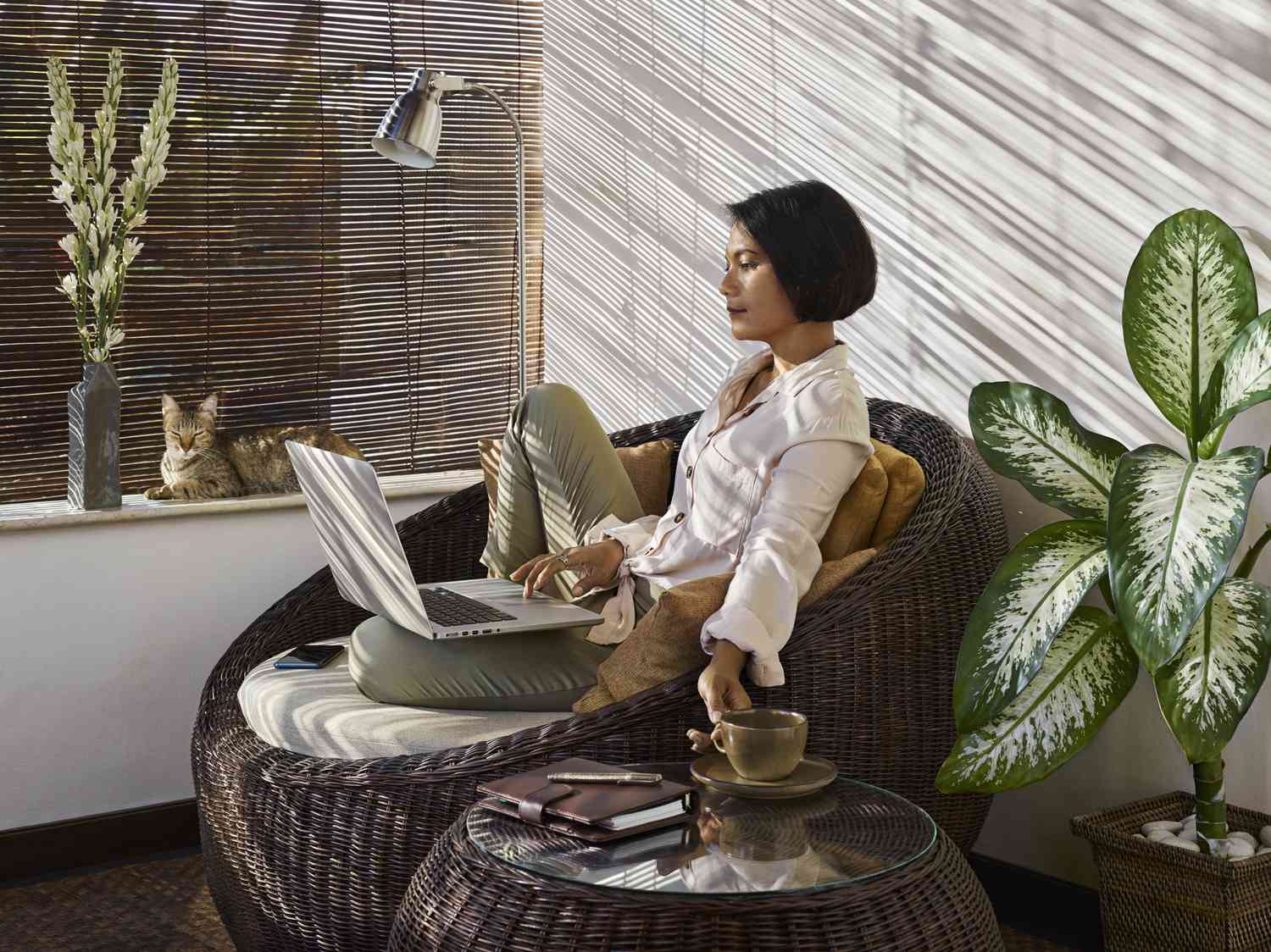 A woman uses a laptop in a home.