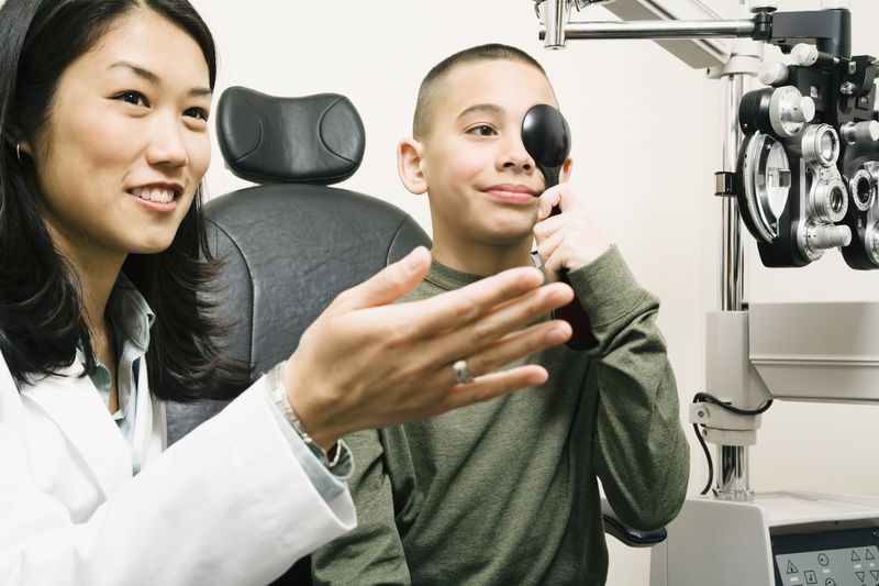 An optometrist checks a child's vision.