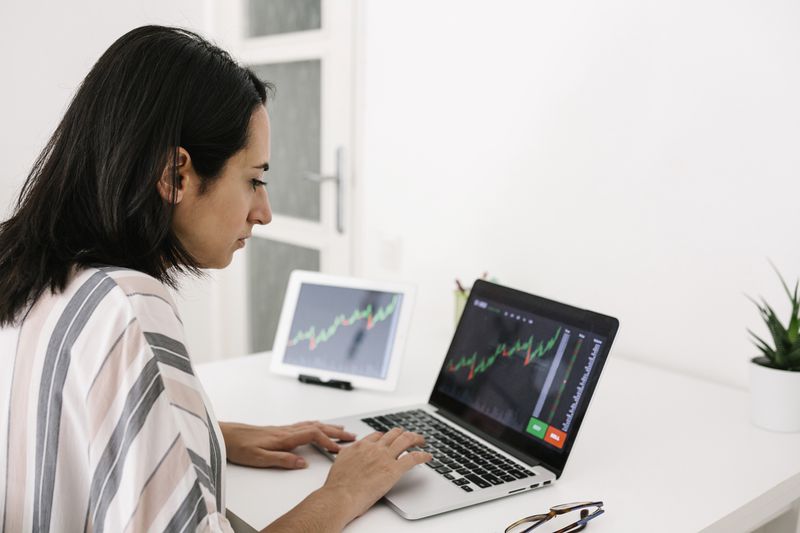Trader looking at stock charts and deciding to invest in a speculative stock.